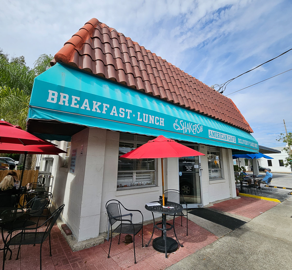 front of shakers restaurant with blue awning